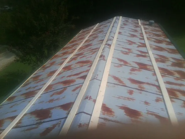 Rusted metal roof panels with new wood purlins before replacement — Storm Damage Roof Repair in Moss Point by Roofing Brothers